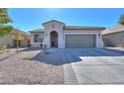 Inviting single-level home featuring a desert landscape, a two-car garage and a welcoming covered entryway at 2393 E San Gabriel Trl, Casa Grande, AZ 85194