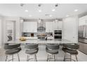 Modern kitchen featuring granite countertops, an island with seating, and stainless steel appliances at 25913 W Sands Dr, Buckeye, AZ 85396