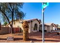 Corner lot house with well-maintained desert landscaping and a red privacy fence at 2716 N Kristen --, Mesa, AZ 85213