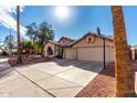 View of the facade of the house from the driveway including a basketball hoop at 2716 N Kristen --, Mesa, AZ 85213