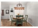 Cozy dining area with a round table, green chairs, and a stylish light fixture at 2977 W Mira Dr, San Tan Valley, AZ 85144