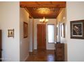 Welcoming entryway featuring decorative ceilings, stylish tile flooring, and a rustic wood front door at 3007 W Jordon Ln, Phoenix, AZ 85086