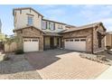 Beautiful home showcasing a brick driveway, 3-car garage, and a cozy front porch at 3551 E Shannon St, Gilbert, AZ 85295