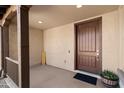 Inviting front porch features a dark wooden door, columns, and decorative potted plants at 3551 E Shannon St, Gilbert, AZ 85295