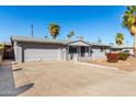 Single story home with gray painted brick, attached garage and low-maintenance landscaping at 3614 W Georgia Ave, Phoenix, AZ 85019