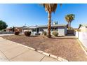 Charming single-story home with gray painted brick and low-maintenance landscaping at 3614 W Georgia Ave, Phoenix, AZ 85019