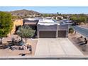 Aerial view of a Southwestern-style home with a two car garage and desert landscaping at 4309 S Priceless View Dr, Gold Canyon, AZ 85118