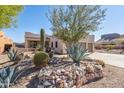 Southwestern-style home with desert landscaping featuring cacti, agave, and a rock retaining wall at 4309 S Priceless View Dr, Gold Canyon, AZ 85118