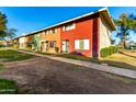 The exterior of the townhomes include grass front yards, sidewalks, and colorful exterior paint schemes at 4341 W Ocotillo Rd, Glendale, AZ 85301