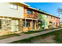 A row of townhomes with a sidewalk leading to the front doors, with multiple color schemes at 4341 W Ocotillo Rd, Glendale, AZ 85301