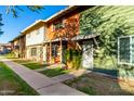 Multi-colored townhomes showcase unique charm and curb appeal with sidewalks and green lawns at 4341 W Ocotillo Rd, Glendale, AZ 85301