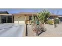 Landscaped front yard of a home featuring native cacti and xeriscaping for low maintenance at 4428 W Mission Ln, Glendale, AZ 85302