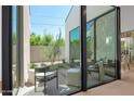 View of private courtyard with seating area visible through large glass wall from the hallway at 4704 N 40Th Pl, Phoenix, AZ 85018