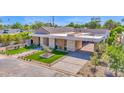 Modern home featuring a covered driveway and professionally landscaped front yard in a suburban neighborhood at 4704 N 40Th Pl, Phoenix, AZ 85018
