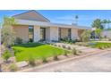 Beautiful front exterior with vibrant green lawn, desert landscaping, and a modern design with a carport at 4704 N 40Th Pl, Phoenix, AZ 85018