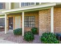 Inviting townhouse exterior featuring brick facade, decorative rock landscaping and thriving green bushes at 4842 E Kachina Trl # 3, Phoenix, AZ 85044