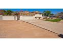 Home exterior with a large driveway leading to a two-car garage and gated yard at 5226 W Tierra Buena Ln, Glendale, AZ 85306