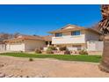 Two-story home with a neutral exterior, well-kept lawn, and mature landscaping at 5226 W Tierra Buena Ln, Glendale, AZ 85306