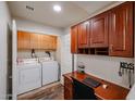 A combined laundry/office space showcases storage cabinets and modern washer/dryer at 5350 E Deer Valley Dr # 2246, Phoenix, AZ 85054