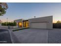 Modern home showcasing a clean design, wide driveway, xeriscaping, and an attached garage at 5910 N 45Th St, Phoenix, AZ 85018