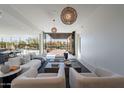 Bright, open living room featuring stylish furnishings, contemporary lighting, and seamless flow to the outdoor patio at 5910 N 45Th St, Phoenix, AZ 85018