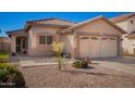 Inviting single-Gathering home with a two-car garage, sidewalk, and desert landscaping at 661 E Redondo Dr, Gilbert, AZ 85296