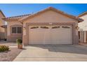 Charming single-Gathering home featuring a two-car garage and low maintenance desert landscaping at 661 E Redondo Dr, Gilbert, AZ 85296