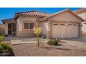 Inviting single-Gathering home with a two-car garage, sidewalk, and desert landscaping at 661 E Redondo Dr, Gilbert, AZ 85296