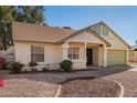 Charming single-story home featuring a two car garage and a desert landscaped front yard at 7737 W Cherry Hills Dr, Peoria, AZ 85345