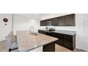 Spacious kitchen island with granite countertops, stainless steel appliances, and dark cabinets at 7751 W Forest Grove Ave, Phoenix, AZ 85043