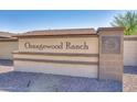 Orangewood Ranch community sign showcasing the neighborhood's name and decorative emblem on a stone pillar at 8009 W Northview Ave, Glendale, AZ 85303