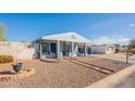 Charming home featuring a covered porch, and front yard with rock landscaping at 8126 E Billings St, Mesa, AZ 85207