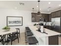 Stylish kitchen with a large island, pendant lighting, and modern stainless steel appliances at 8149 E Petunia Ave # 1041, Mesa, AZ 85212