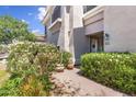 Inviting home entrance framed with lush flowering bushes at 8180 E Shea Blvd # 1038, Scottsdale, AZ 85260