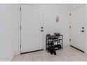 Bright entryway with tiled floors, shoe storage, and white door presents a clean and organized space at 8188 N 22Nd Dr, Phoenix, AZ 85021