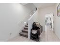 Hallway with carpeted stairs, tiled flooring, and ample lighting gives a modern and inviting feel at 8188 N 22Nd Dr, Phoenix, AZ 85021