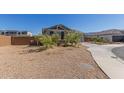 Single-story home with desert landscaping, a driveway, and a brick fence at 9313 S 39Th Dr, Laveen, AZ 85339