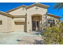 Inviting front entrance featuring a decorative security door, an arched entryway and desert landscaping at 9590 W Bajada Rd, Peoria, AZ 85383