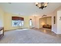 Spacious living room featuring neutral walls, a large window, carpeted floors and decorative lighting at 9590 W Bajada Rd, Peoria, AZ 85383