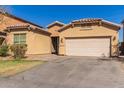 Charming single Gathering home with a two car garage and well maintained front yard and a lovely desert landscape at 10004 W Raymond Street St, Tolleson, AZ 85353