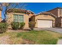 Charming single Gathering home with a two car garage and well maintained front yard and a lovely desert landscape at 10004 W Raymond Street St, Tolleson, AZ 85353