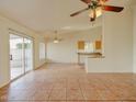 Spacious living area featuring sliding glass doors to the backyard and an open layout at 1052 W Paseo Way, Tempe, AZ 85283