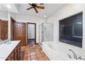 Bathroom featuring double sinks, a soaking tub, a tiled shower, and walk in closet at 1235 E Clearview Dr, Casa Grande, AZ 85122
