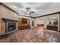 Spacious living room boasting a fireplace, tiled floors, and access to a wet bar at 1235 E Clearview Dr, Casa Grande, AZ 85122