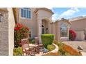 Charming home entrance with stone pathway and decorative landscaping, complemented by a cozy seating area at 1302 E Voltaire Ave, Phoenix, AZ 85022