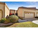 Charming home exterior with a well-maintained lawn, a two car garage, and desert landscaping at 19035 N 83Rd Ln, Peoria, AZ 85382