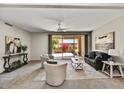 Bright living room with sliding doors to a patio, neutral toned walls, and contemporary furnishings at 19035 N 83Rd Ln, Peoria, AZ 85382