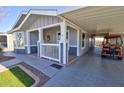 Single story home with a golf cart under the carport and a lovely front porch at 2263 N Trekell Rd # 21, Casa Grande, AZ 85122