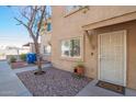 Inviting townhome exterior with security screen door, desert landscaping and a welcoming front entrance at 2277 S Apache Dr # 7, Apache Junction, AZ 85120