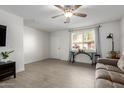Bright living room featuring tile floors, ceiling fan, comfortable sofa, and lots of natural light at 2277 S Apache Dr # 7, Apache Junction, AZ 85120